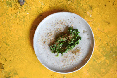 295 Ein Gericht mit Spinat auf einem Teller, von oben fotografiert