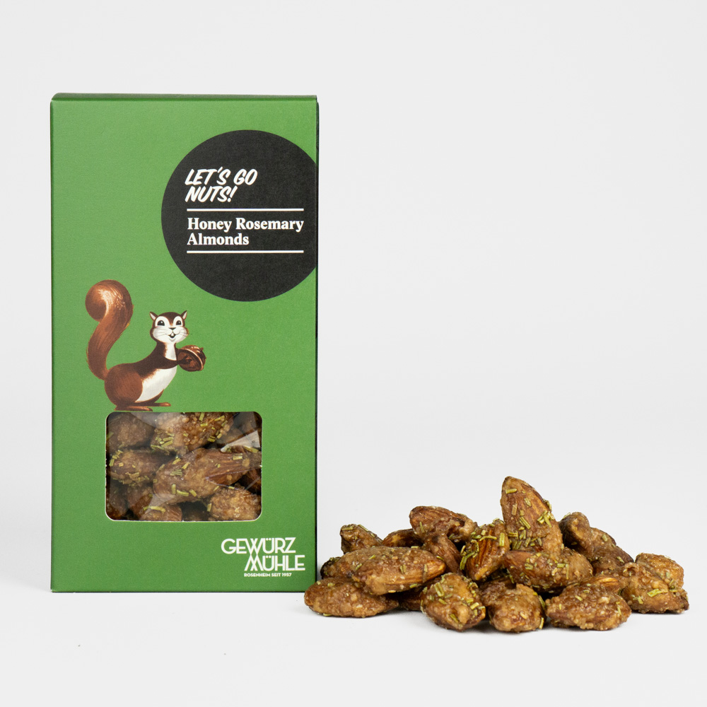 Nüsse in Pappverpackung mit Sichtfenster, ausgeschüttete Nüsse daneben - Honey Rosemary Almonds