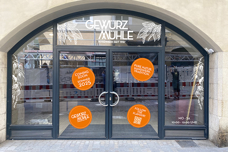 Ladenfront des Regensburger Ladens mit orangen "Coming soon" Aufklebern