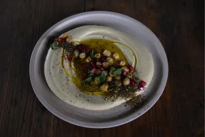 Hummus-Gericht auf einem Teller, von oben fotografiert.